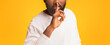© Prostock-studio - Mystery, silence, secret concept. Cropped photo of afro man showing hush gesture, panorama with copy space
