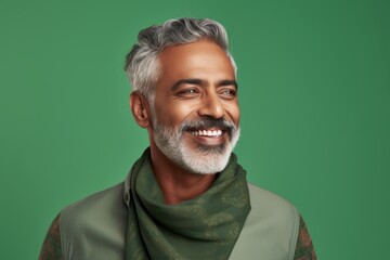 Canvas Print - Portrait of a glad indian man in his 50s donning a trendy cropped top over soft green background