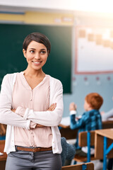 Poster - Woman, teacher and happy with arms crossed in classroom for teaching, learning and education in elementary school. Female person, professional and smile or proud in confidence with career growth