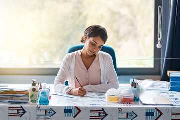Poster - Woman, educator and writing in classroom for student exercise, test and assessment for brain development. Female person, teacher and marking or grading with learner assignment and creativity