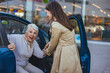 © Dragana Gordic - Senior Woman Receiving Help from Friend to Exit Car