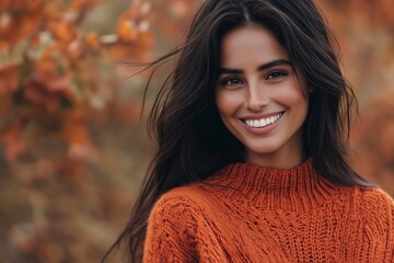 Poster - A woman with long hair is smiling and wearing an orange sweater. The image has a warm and inviting mood, with the woman's smile and the bright orange sweater creating a sense of happiness and comfort