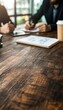 © DuangphonKPR - A pair of entrepreneurs, sitting in a shared workspace, comparing loan terms with notebooks and charts