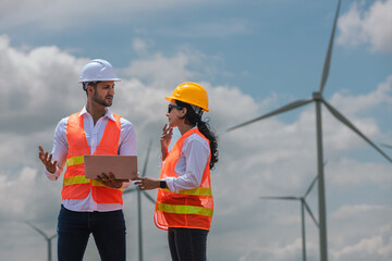Fototapete - man and woman engineer worker wind turbine handshake success agreement survey discuss operational planning. Windmill field clean energy sustainable clean. engineering nature power alternative.