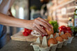 © Geber86 - Woman cracking an egg for healthy breakfast preparation in kitchen