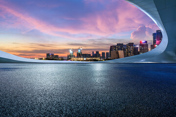asphalt road square and city skyline with modern buildings scenery at night. car advertising backgro