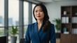 © Alteisen Riese - adult black hair east asian woman in blue formal attire model portrait looking confident on an office background for ad concept space for text
