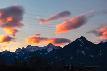 Breathtaking sunset over silhouette of snow-capped majestic mountain peak Vertatscha in Carinthia, Austria, Europe. Sky is ablaze with vibrant hues of orange, pink. Rosental in winter, Austrian Alps