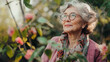 © katildam - attractive and stylish elderly woman knzvn stands against the background of a blooming garden and smiles thoughtfully