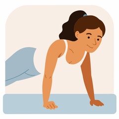 A woman is doing a push up on a mat. She is smiling and she is enjoying herself