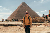 man in front of the great pyramids of Giza