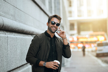 Poster - Man, happy and phone call with sunglasses in city for communication, morning commute and waiting for cab. Person, smile and talking on smartphone with coffee for networking and discussion on sidewalk