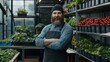 © irissca - Urban farmer at work in a bustling greenhouse surrounded by fresh produce