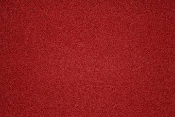 the vibrant red surface features fine grains and a smooth texture, highlighting the richness of colo