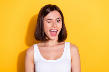 Wall Mural - Photo of cunning funky lady dressed white top smiling winking eye open mouth isolated yellow color background