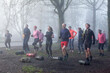 © Connect Images - Group of adults engaging in an outdoor exercise bootcamp amidst foggy conditions, displaying teamwork and physical fitness.