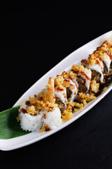 Wall Mural - Tempura shrimp maki roll with cucumber Japanese food isolate in black background