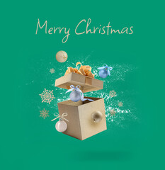 Sticker - Merry Christmas greeting card with gift box, decorative balls and snowflakes in air on teal background