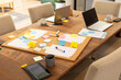 © wavebreak3 - Brainstorming ideas, friends using laptops and sticky notes on wooden table