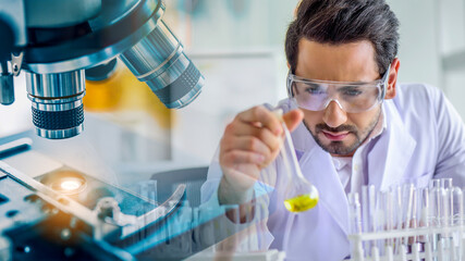 Wall Mural - scientist or chemist using microscope with laboratory glassware, science research and development co