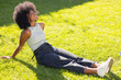 © wavebreak3 - Sitting on grass, young woman smiling and enjoying sunny day outdoors, copy space