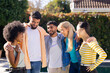 © wavebreak3 - Group of young diverse friends standing together outdoors, smiling and embracing each other