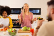 © wavebreak3 - Cooking together, young diverse friends preparing vegetables and enjoying time in kitchen