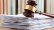 © alphaonetwo - A gavel resting on a stack of legal paperwork