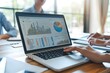 © Imagentive - Business Meeting Analysis on Laptop Screen with Charts and Graphs
