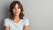 © Michael - Young woman exudes a confident and approachable demeanor as she smiles subtly with her arms folded