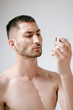 © Elina Leonova - Man using cream. Health care concept. SPA