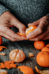 Wall Mural - man at a table peeling a tangerine