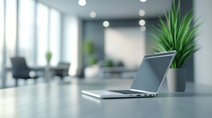 Poster - Open laptop computer sits on a desk in a modern, well-lit office next to a potted plant