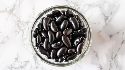 Wall Mural - A bowl of black beans is shown in a glass jar