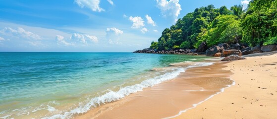 A beautiful beach with a clear blue ocean and a rocky shore