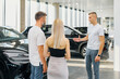 © makedonski2015 - Business concept, man and woman came to car dealership to buy a car
