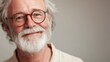 © Elmira - An elderly man with a silver beard and round glasses displays a gentle smile, reflecting a lifetime of experiences and wisdom in a soft, inviting atmosphere