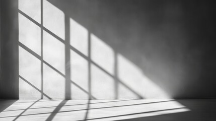Poster - Soft light streams through a minimalist window, creating elongated shadows on the smooth, plain wall. The contrast enhances the tranquil ambiance of the space