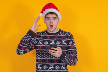 Poster - young man with christmas clothes and santa claus hat isolated