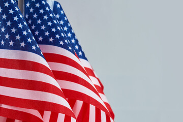 American Flags. Three American flags with stars and stripes on a light blue background.