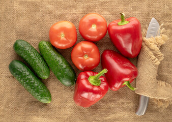 Wall Mural - Fresh ripe vegetables on jute cloth, macro, top view.