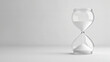 © Elmin - A clear image of a classic hourglass, with its sand slowly flowing,  set against a plain white backdrop.