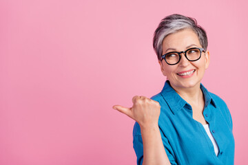 Sticker - Photo portrait of pretty retired female look point empty space wear trendy blue outfit isolated on pink color background