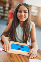 Poster - Girl, happy and portrait in library for study, education and learning with childhood development. Student, book and excited in school for english reading, knowledge or academic information with smile