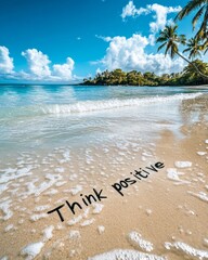 Sticker - The words 'Think positive' are written in the sand on a tropical beach with blue water, white clouds, and palm trees in the background.