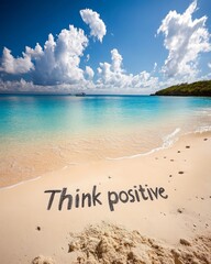 Poster - The words 'Think positive' written in the sand on a beautiful tropical beach with blue ocean and sky.