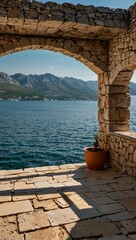 Wall Mural - Outdoor terrace with rustic stone wall and sea view in Montenegro.