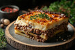 © Dzmitry - Savoring traditional Greek moussaka with beef mince, a comforting dish perfect for gatherings and family meals any time of year