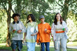© Seventyfour - Medium shot of diverse group of four cheerful teenagers walking outside in park enjoying communication and sunny day during summer break, copy space
