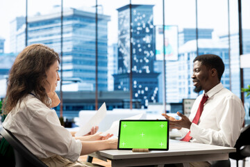 Wall Mural - HR expert works on isolated screen tablet, identifying candidates for job opening, reviewing resumes to determine candidate qualifications. Headhunter doing screening process with chroma key device